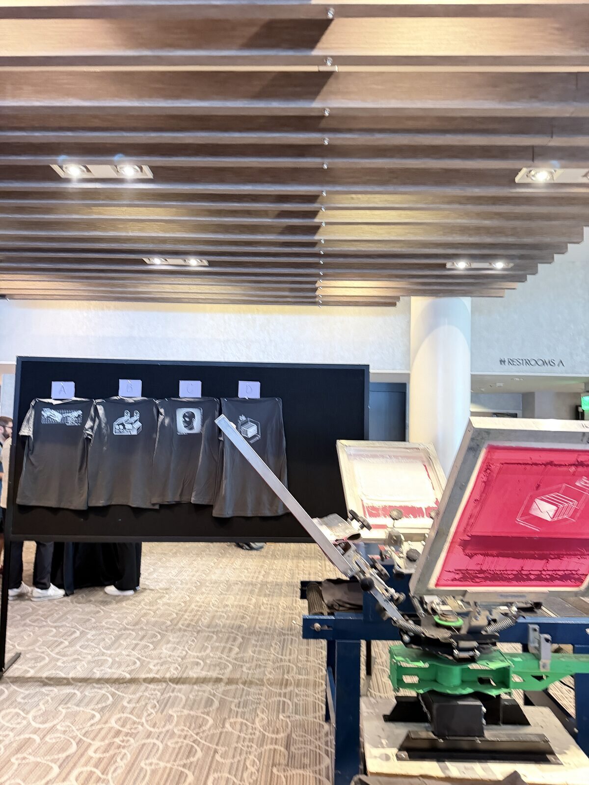 Merch Troop live printing — fresh prints off the platen